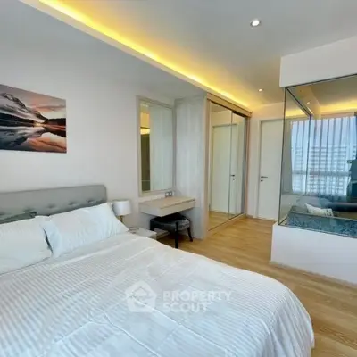 Modern bedroom with glass partition and elegant lighting