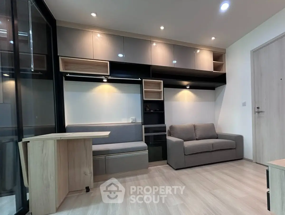 Modern living room with sleek furniture and built-in storage solutions