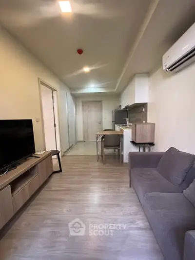 Modern living room with sleek furniture and open kitchen layout