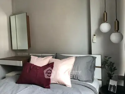 Modern bedroom with stylish pendant lights and cozy bedding