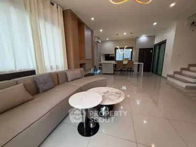 Spacious modern living room with elegant decor and open kitchen layout