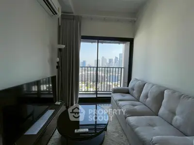 Modern living room with city view, featuring a sleek sofa and large TV, perfect for urban living.