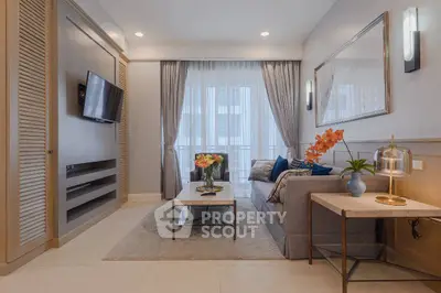 Elegant living room with modern decor and large window for natural light