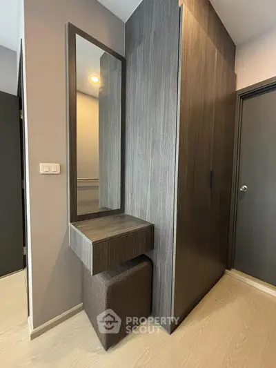 Modern bedroom corner with sleek wooden wardrobe and stylish vanity mirror