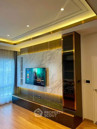 Luxurious living room with modern TV setup and elegant lighting