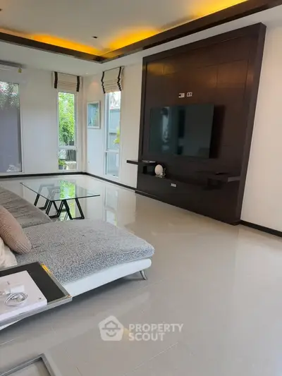 Spacious modern living room with sleek design and large windows offering natural light.