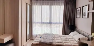 Modern bedroom with large window and stylish decor in a high-rise apartment.