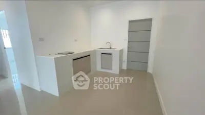Minimalist kitchen with sleek design and modern fixtures in a bright, open space.