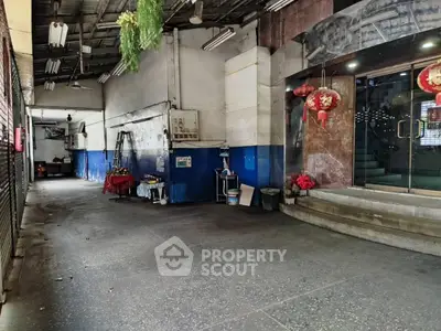 Spacious industrial-style entrance with high ceiling and decorative lanterns.