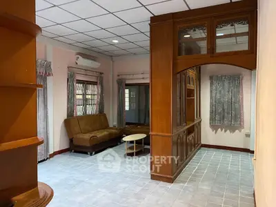 Spacious living room with elegant wooden partition and cozy seating area.