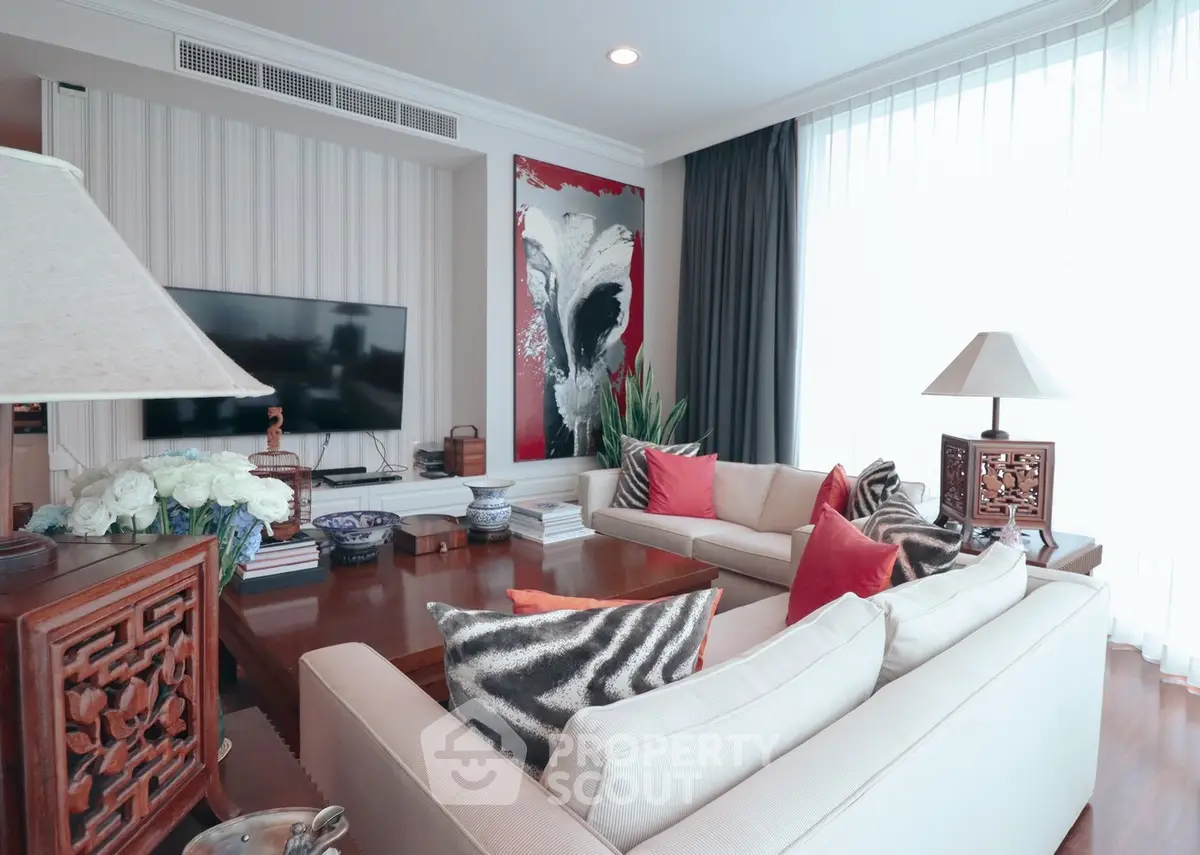Elegant living room with modern decor, large windows, and stylish furniture.
