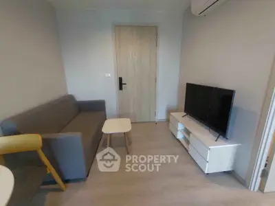 Cozy living room with modern furniture and air conditioning, perfect for relaxation.