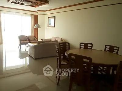 Spacious living room with elegant dining area and natural light