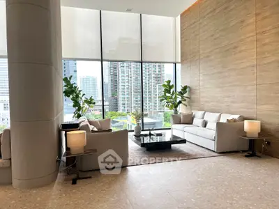 Luxurious modern living room with panoramic city view and elegant decor.