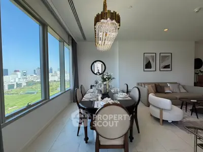 Luxurious dining and living area with panoramic city views and elegant chandelier.
