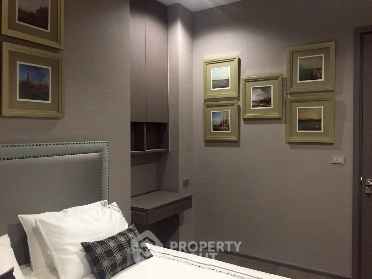 Elegant bedroom with stylish decor and framed artwork on walls