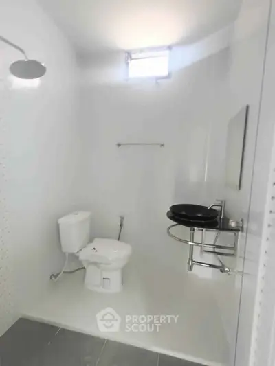 Modern minimalist bathroom with sleek fixtures and bright lighting