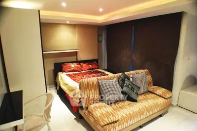 Cozy bedroom with modern decor and comfortable seating area