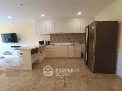Spacious kitchen with modern appliances and elegant cabinetry, perfect for culinary enthusiasts.