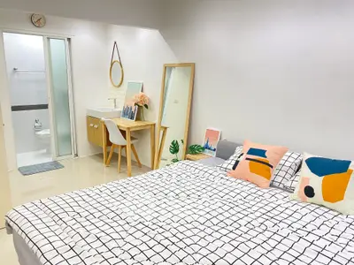 Modern bedroom with stylish decor and ensuite bathroom, featuring a cozy bed and chic furnishings.