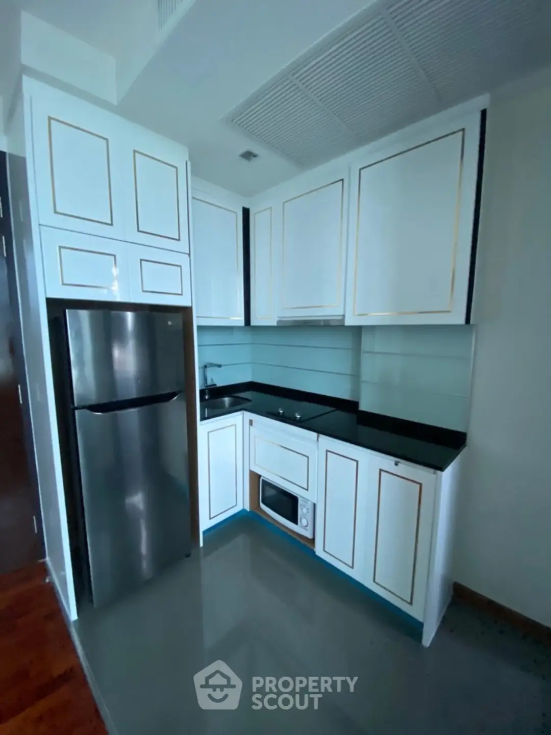 Modern compact kitchen with sleek cabinetry and stainless steel appliances