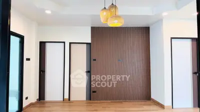 Modern interior with wooden flooring and stylish pendant lights