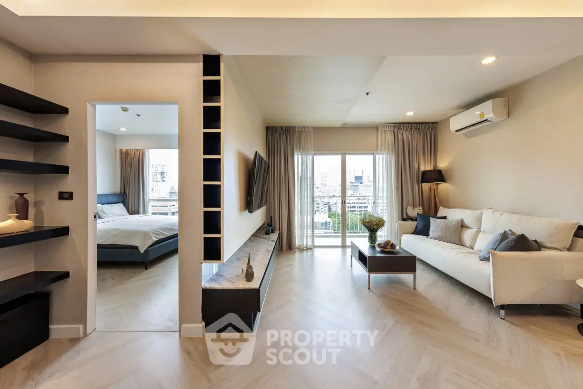 Modern living room with elegant decor and city view from balcony