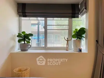 Cozy bedroom window with potted plants and natural light