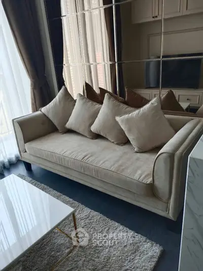 Elegant living room with plush beige sofa and modern decor