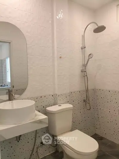Modern bathroom with sleek shower and stylish sink in a contemporary home.