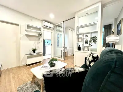 Modern living room with stylish decor and open layout, featuring cozy seating and elegant furnishings.