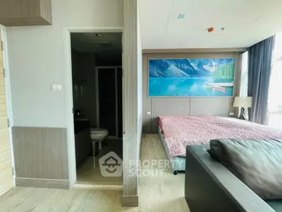 Modern bedroom with ensuite bathroom and scenic wall art, featuring sleek design and natural light.