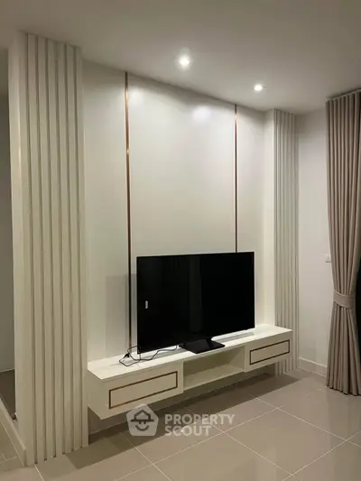 Modern living room with sleek TV unit and elegant curtains