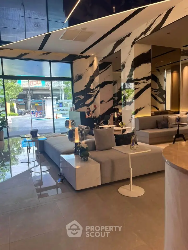 Luxurious modern living room with stylish marble accents and elegant furniture, perfect for sophisticated urban living.