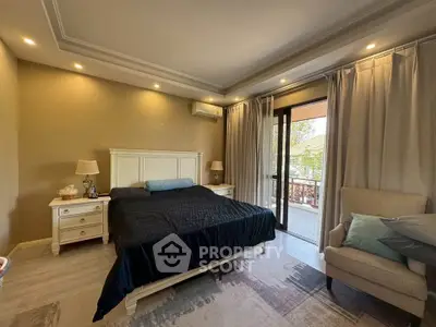 Spacious bedroom with elegant decor and balcony access, featuring modern lighting and cozy furnishings.