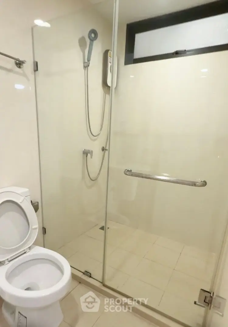 Modern bathroom with glass shower enclosure and sleek fixtures