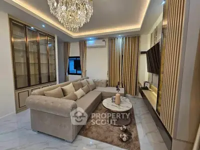 Luxurious living room with elegant chandelier and plush seating