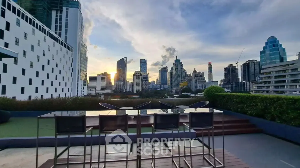 Stunning rooftop view with modern city skyline at sunset, perfect for urban living.