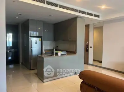 Modern kitchen with sleek cabinetry and stainless steel appliances in a stylish apartment.