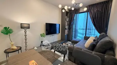 Modern living room with stylish decor and city view, featuring a cozy sofa and elegant lighting.