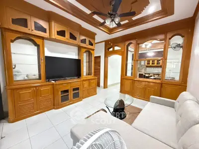 Spacious living room with elegant wooden cabinetry and modern furnishings
