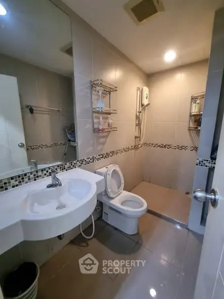 Modern bathroom with sleek fixtures and spacious shower area