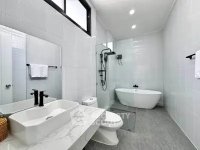 Luxurious modern bathroom with sleek fixtures and freestanding bathtub