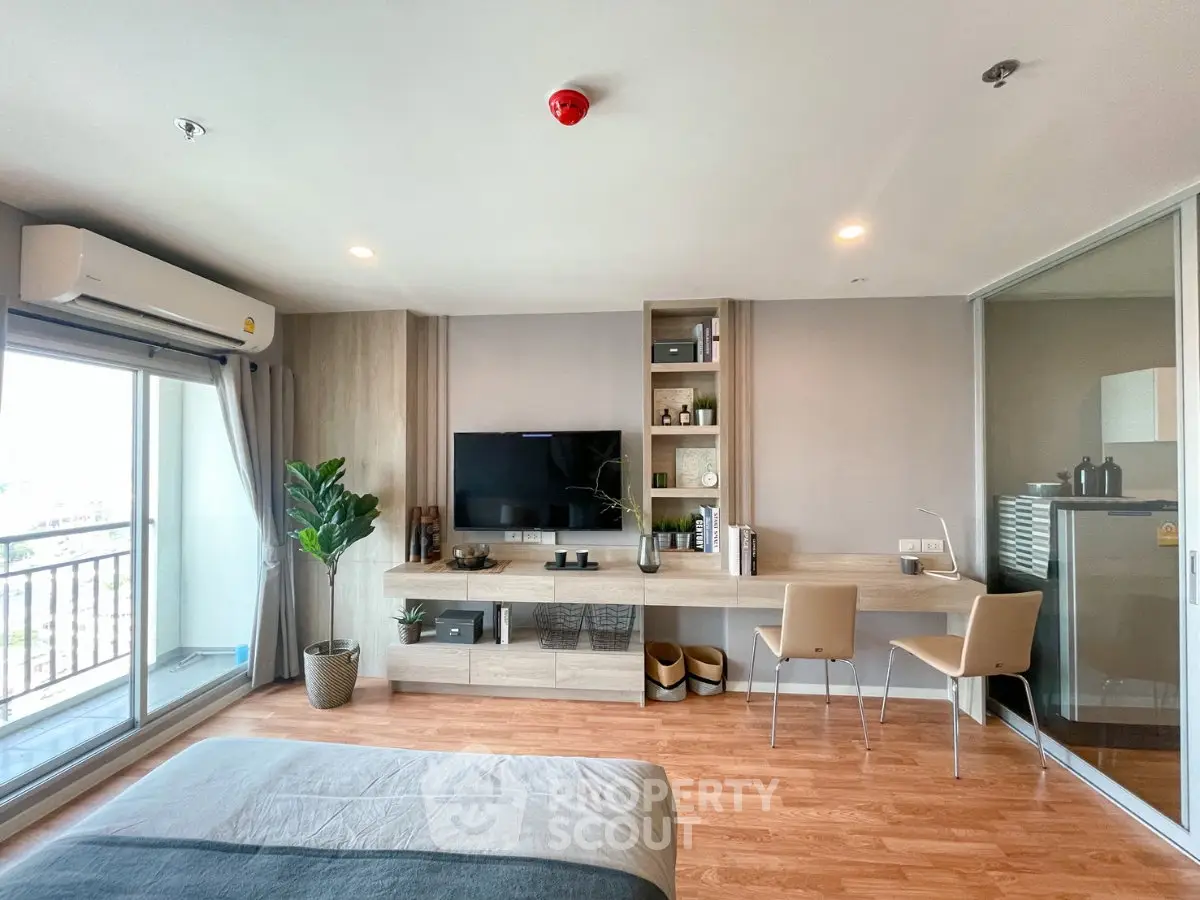 Modern bedroom with balcony, stylish decor, and natural light in a contemporary apartment.