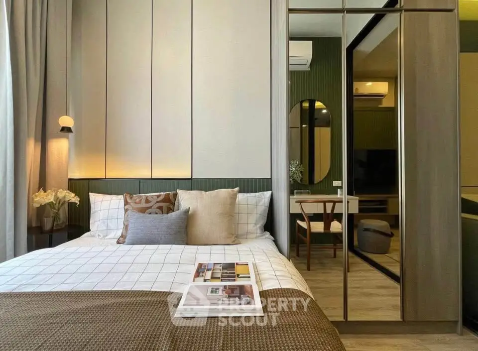 Modern bedroom with stylish decor and mirrored wardrobe, perfect for urban living.