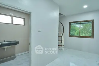 Modern interior with spiral staircase and bathroom, bright natural light