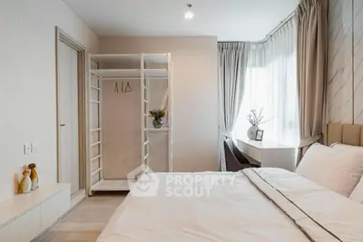 Modern bedroom with open closet and natural light, perfect for cozy living.