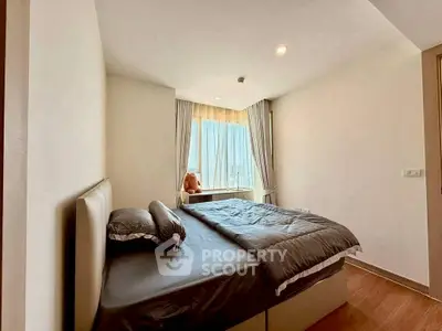 Cozy bedroom with large window and modern decor