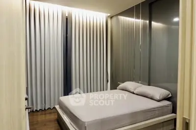 Modern bedroom with sleek design and floor-to-ceiling curtains