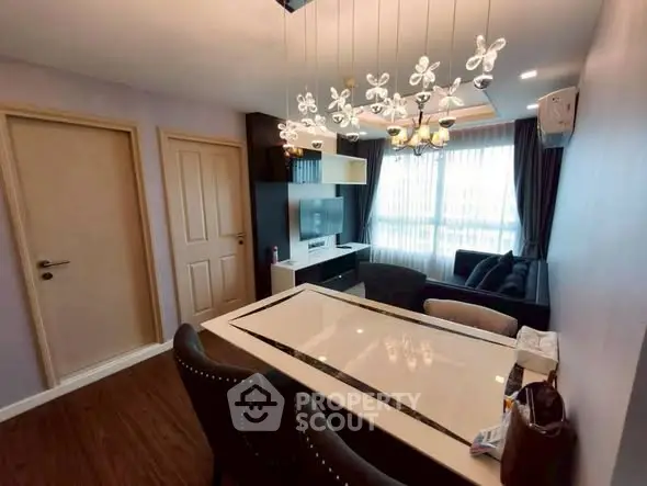 Modern living room with elegant lighting and stylish furniture in a cozy apartment setting.